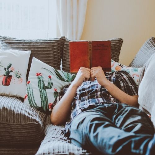 Image of a person in their comfort zone reading a book.