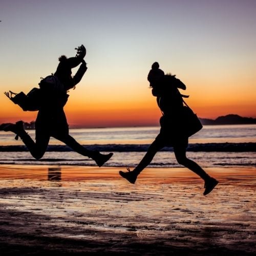 Image of two people jumping for personal growth and the areas of personal development.
