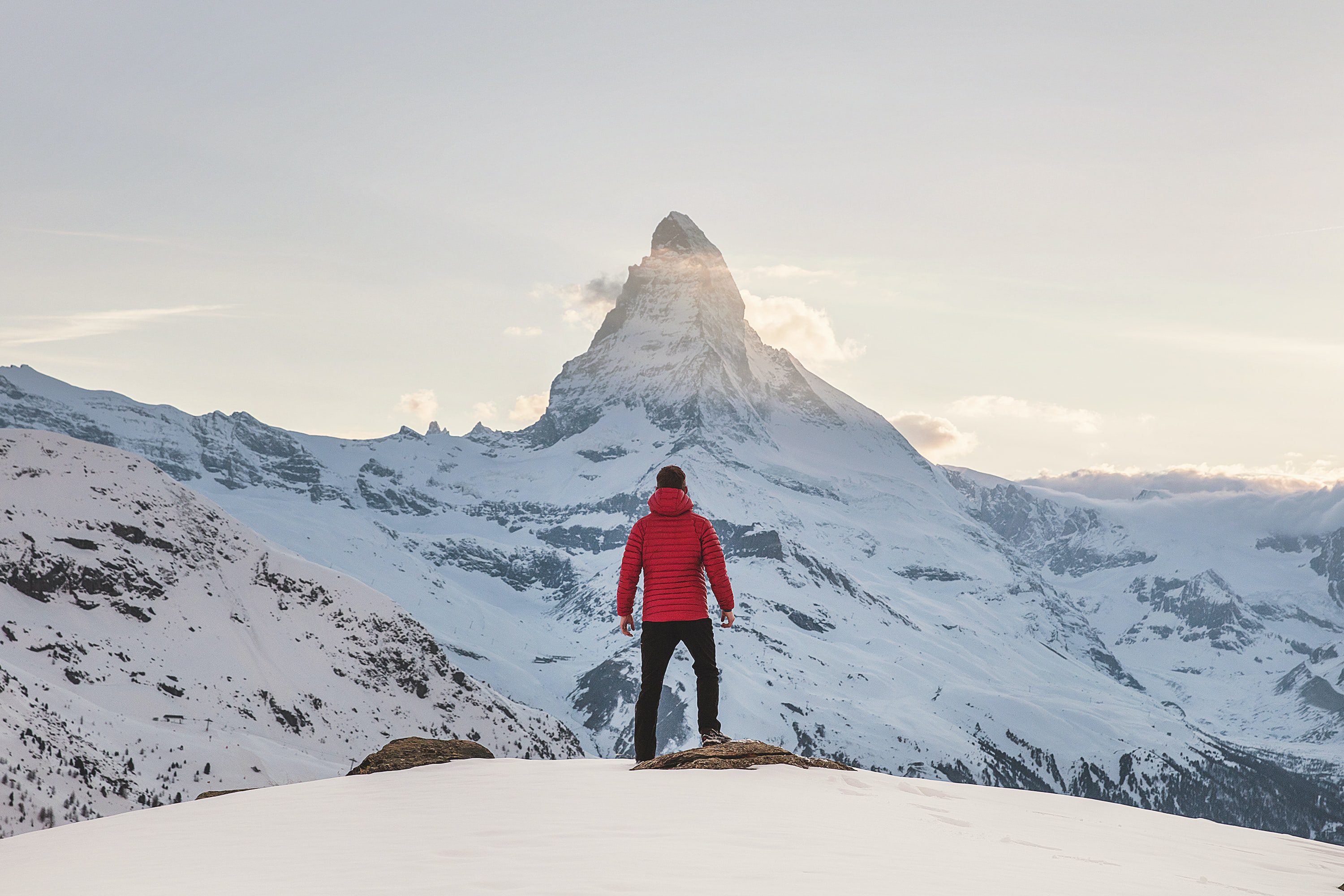 Man looking up at a mountain contemplating his personal mission.