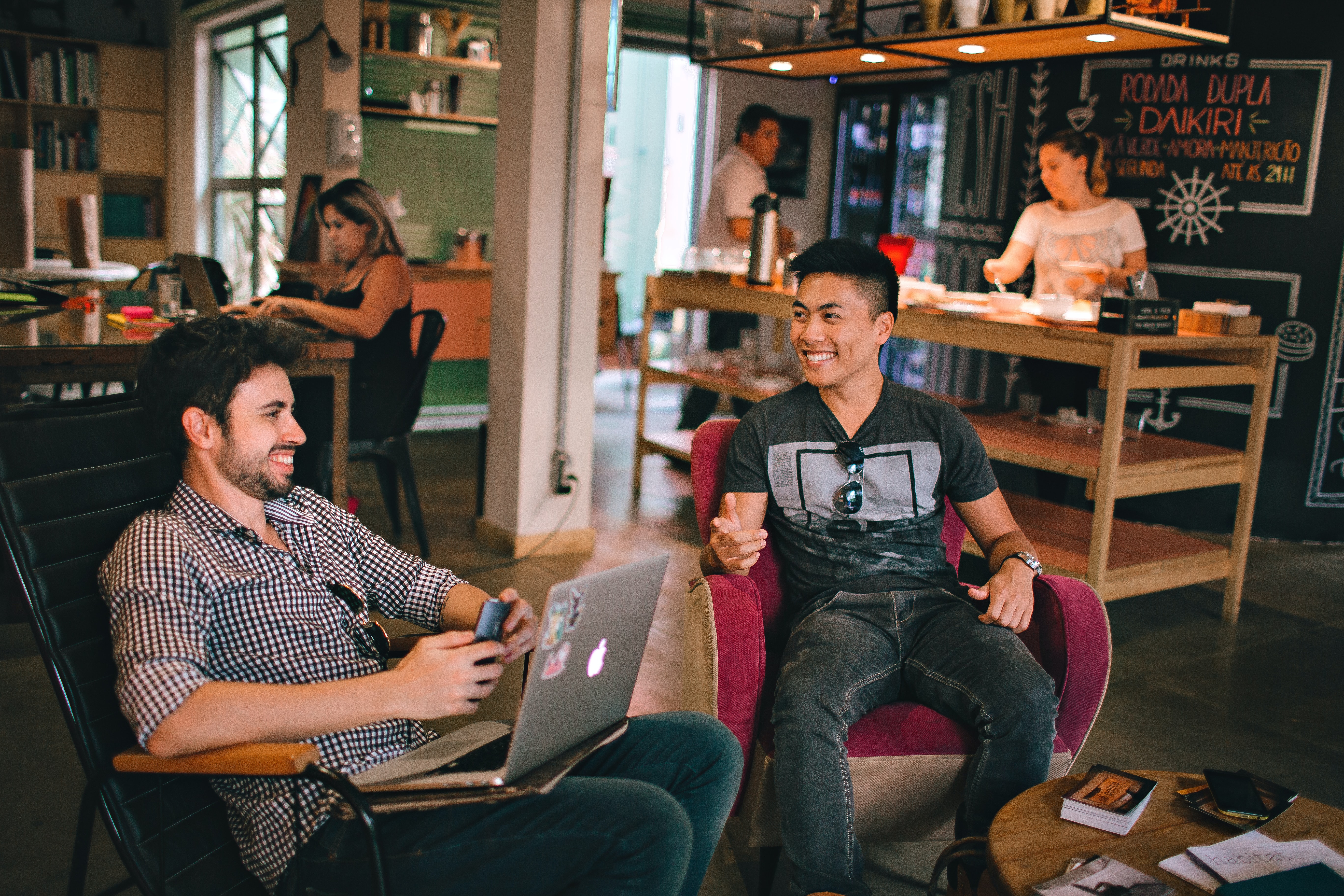 Two people talking in a coffee shop showing the importance of networking