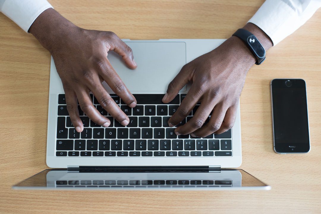 Person typing on a computer sending an email for technology related workplace communication.